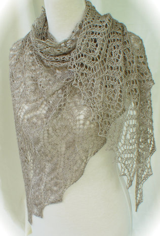 Ethereal Fichu is a sheer, flowing long triangular shoulder wrap knit in geometric lace motifs.