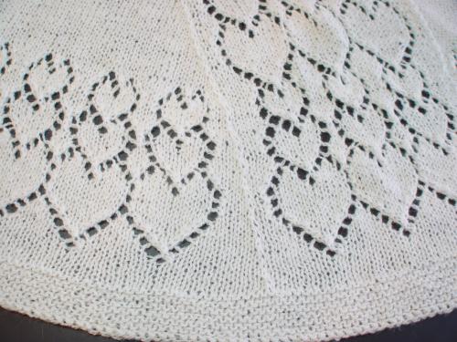 Cascading Hearts Faroese Shawl detail of the center back panel and lower border. Shown in Polwarth 2-ply white laceweight wool