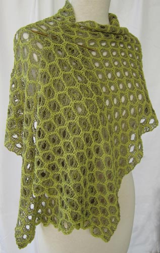 Honeycomb Lace Stole worn pinned at the shoulder with a short knitting needle