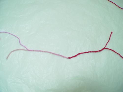 Pull the ends of each yarn until the loops are snugged up around each other.